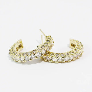 Gold hoop earrings with sparkling crystal embellishments.