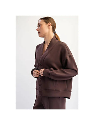 A woman wearing an espresso-colored modal scuba cardigan with button closure and relaxed fit.