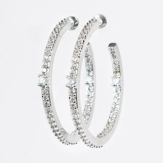 Silver hoop earrings adorned with sparkling crystals and a post back closure.