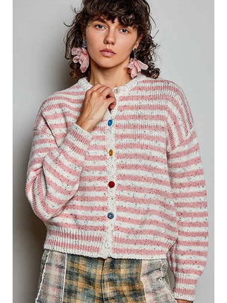 A long sleeve sweater with pink and white stripes and colorful buttons.