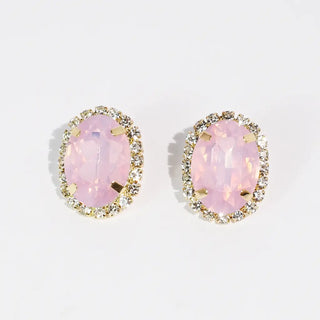 Pink stud earrings with a sparkling halo setting and post back closure.