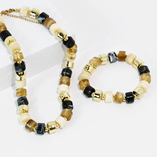 A beaded necklace and bracelet set in mocha tones with gold-toned accents.