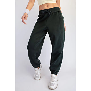 Black jogger pants with a relaxed fit, elastic waistband, and tapered legs with elastic cuffs.