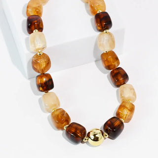 Amber-colored beaded necklace with rounded and polished beads.
