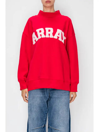 Red pullover with 'ARRAY' varsity-style lettering and a mock neck, worn with jeans.