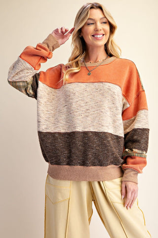 A color-blocked pullover sweatshirt in rust olive with long sleeves and ribbed cuffs.