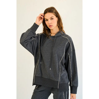 Charcoal relaxed fit hoodie with striped piping detailing, worn by a model.