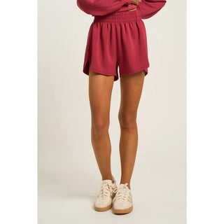 Dark rose soft shorts with an elastic waistband, shown on a model.