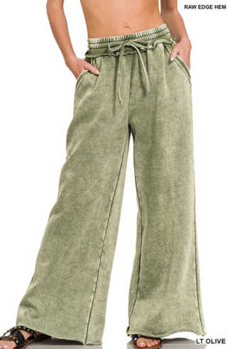 Light olive palazzo sweatpants with a drawstring waist and side pockets, made from acid wash fleece.