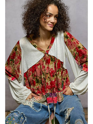 A woman wearing a patchwork ruffle top with ribbed knit and floral prints in ivory multi and toasted almond.