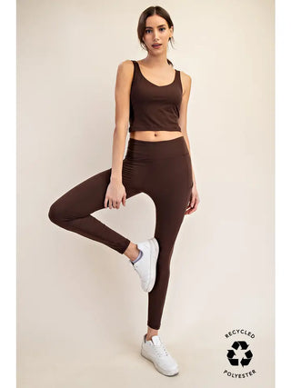 Model wearing espresso-colored leggings with pockets, paired with a matching tank top.