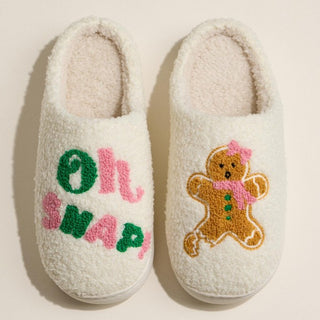 Cream slippers with green and pink 'Oh Snap' embroidery and a gingerbread design.