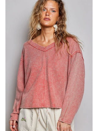 Coral-colored vintage thermal top with a micro-check waffle knit pattern and relaxed fit.
