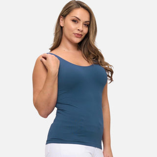 Plus-size woman wearing a denim blue seamless tank top with a built-in bra.