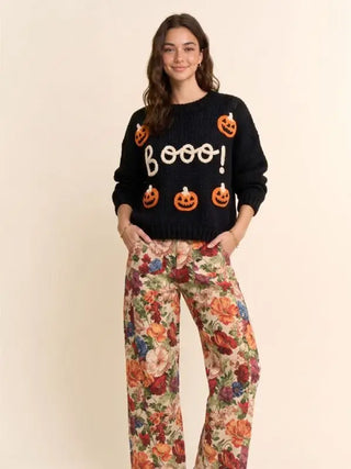 Black knit sweater with pumpkin designs and 'Booo!' graphic.