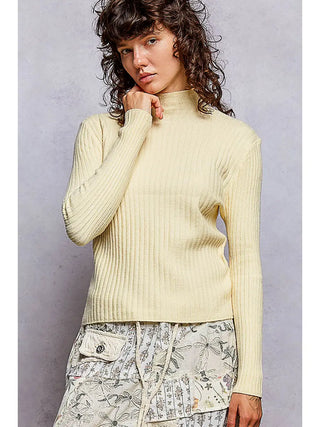 A model wearing a fitted mock neck rib knit sweater in baby yellow.