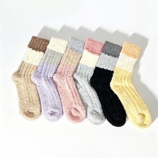 A set of ribbed knit plush crew socks in various colors including cream, pink, yellow, and black, displayed side by side.