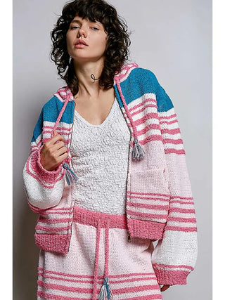 A woman wearing a hoodie sweater with a 3D stripe design in pink multi-color.