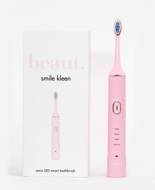 Pink electric toothbrush with LED technology and multiple modes displayed next to its box.
