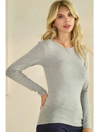 A woman wearing a heather grey ribbed long sleeve top with a crew neckline.