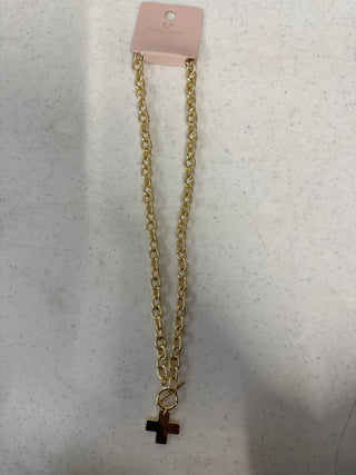 Gold necklace with a link chain and cross pendant.