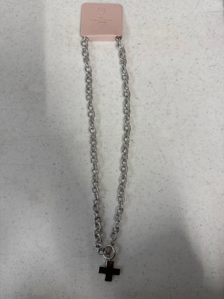 Silver cross necklace with a link chain and polished cross pendant.