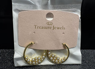 Gold-tone hoop earrings adorned with faux pearls on a display card.