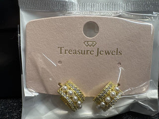 Gold earrings with pearl and crystal embellishments on a display card.