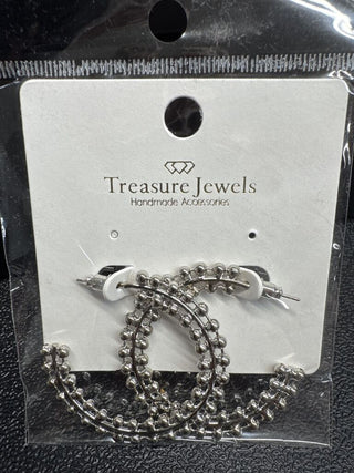 Silver beaded hoop earrings with a post back closure displayed on a card.