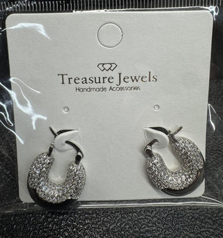 Sparkling silver hoop earrings with crystal embellishments and hinged back closure on display card.