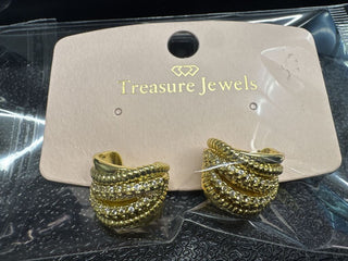 Gold-tone clip-on earrings with rhinestone detailing on a display card labeled 'Treasure Jewels'.