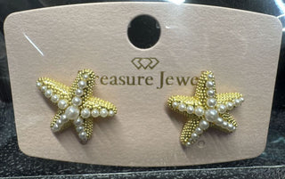 Gold starfish-shaped earrings adorned with pearl accents on a display card.