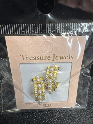 Gold earrings with pearl accents and rhinestones on a display card.