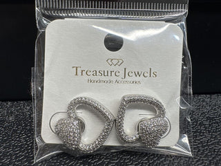 Heart-shaped silver earrings with rhinestones on a display card.