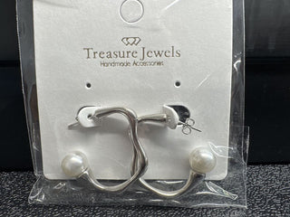 Silver twisted earrings with pearl accents on a display card.