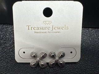 Handmade silver tone earrings with a floral design displayed on a branded card.