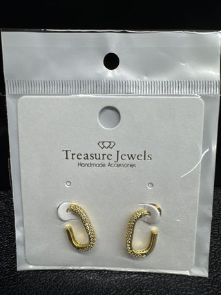 Gold hoop earrings with crystal detailing on a display card from Treasure Jewels.