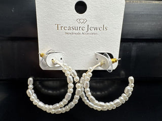 Pearl beaded hoop earrings on a display card with post back closure.