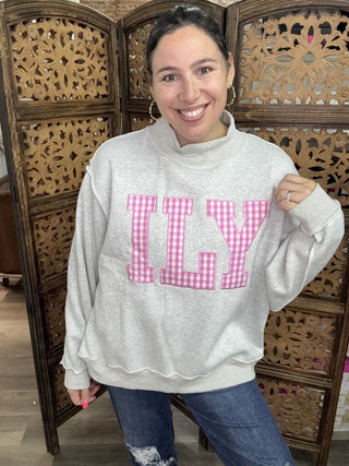 Gray sweatshirt with a pink gingham 'ILY' patch and mock neck worn by a person.
